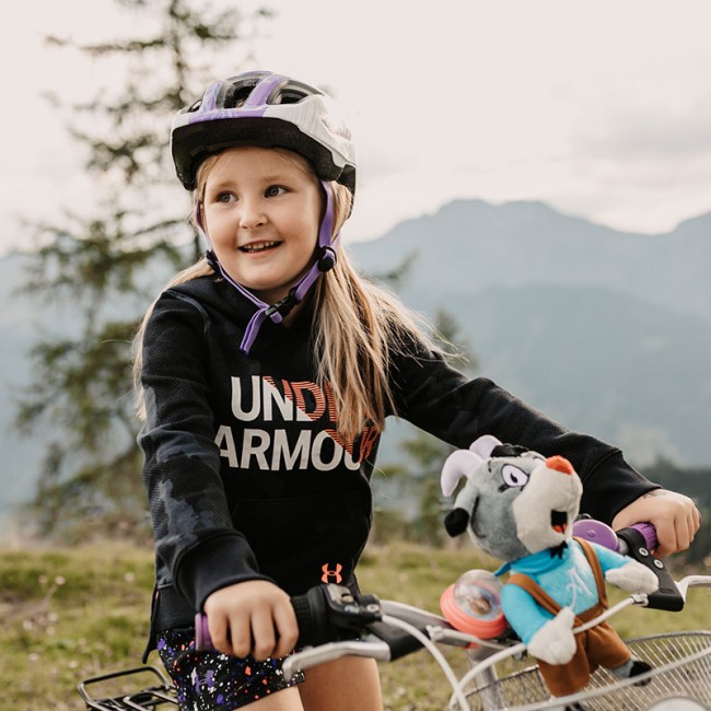 Child cycling in the mountains